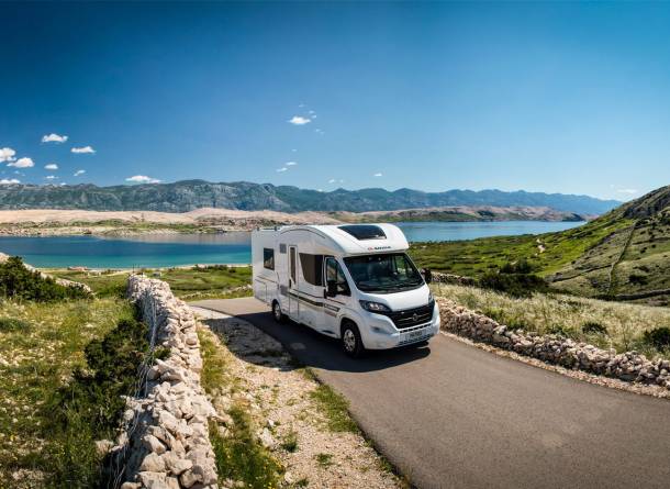 Motorhome on the road near the lake